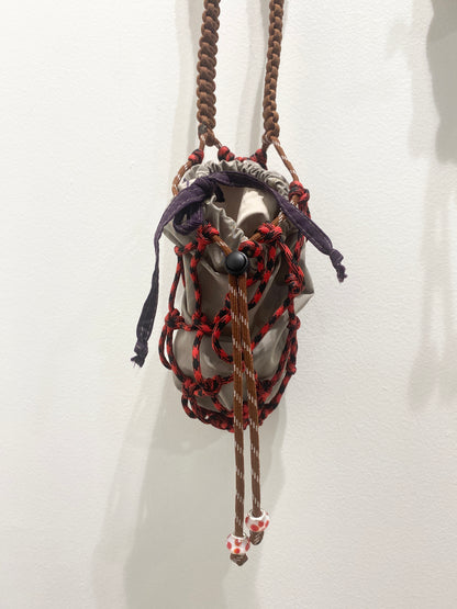 Amihan Aquilizan, bottle bag red/black/brown