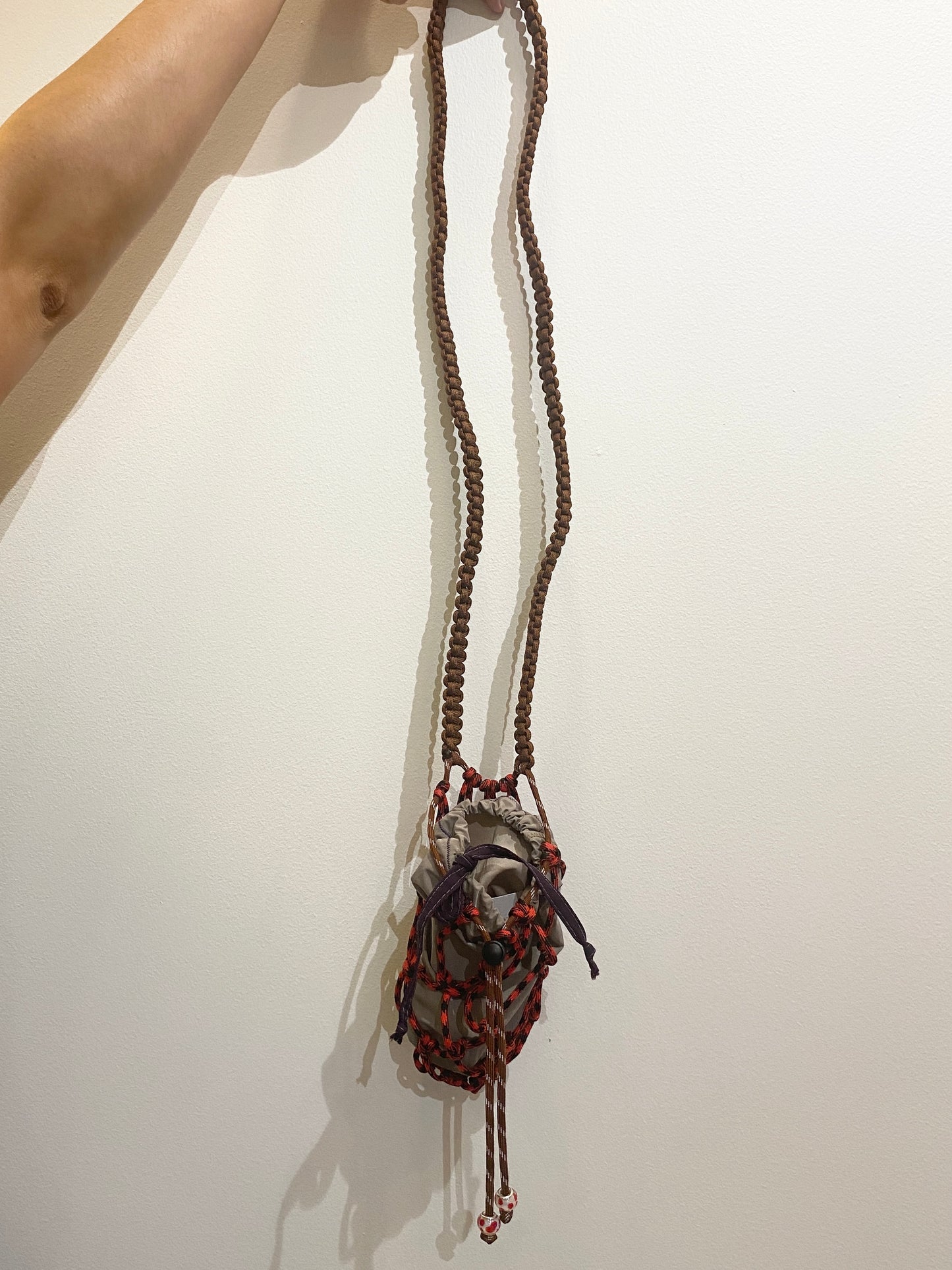 Amihan Aquilizan, bottle bag red/black/brown