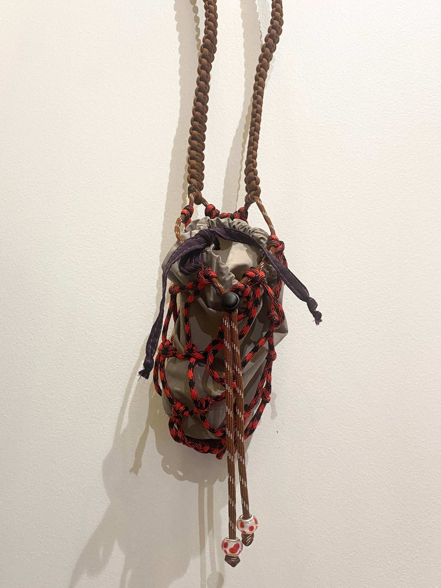 Amihan Aquilizan, bottle bag red/black/brown