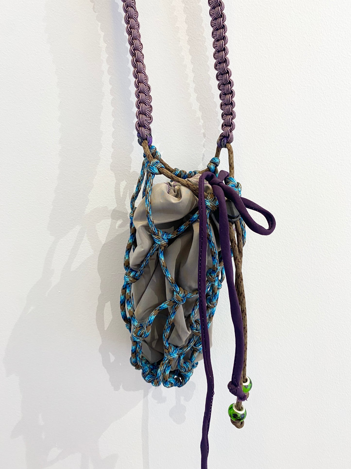 Amihan Aquilizan, over the shoulder bottle bag blue/brown/purple